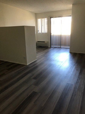 an empty living room with a wood floor