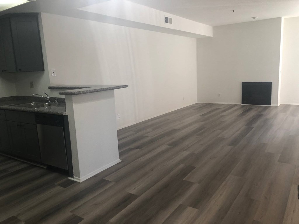 a kitchen and living room with hardwood flooring and