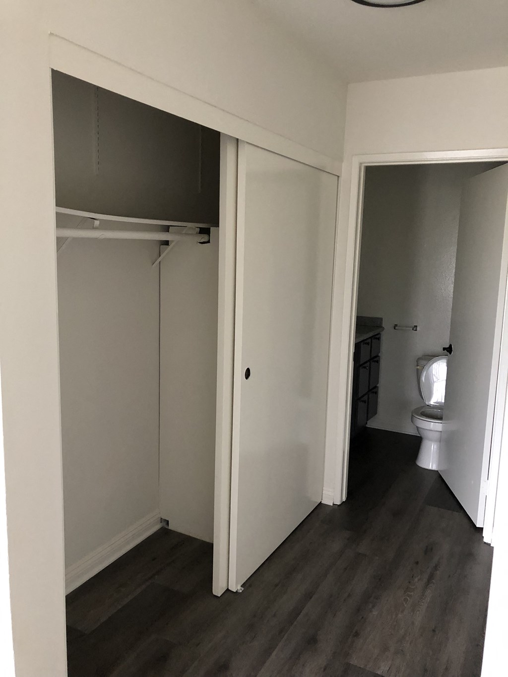 a room with a toilet and a closet in it