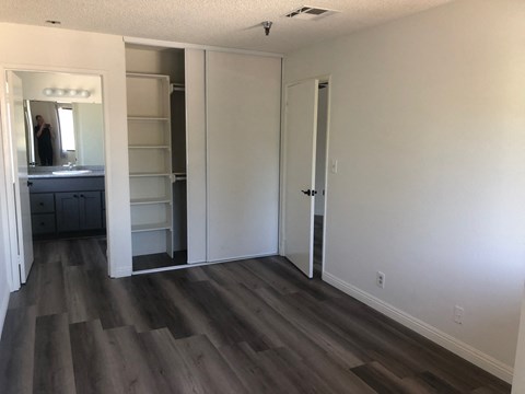 a renovated living room with white walls and wood floors