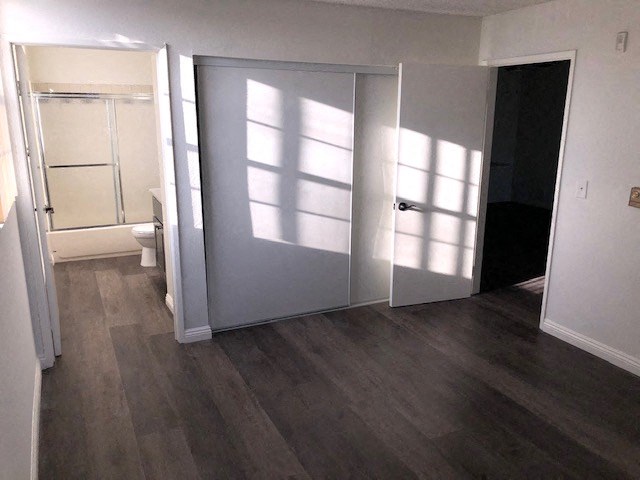 an empty room with a door open to a bathroom