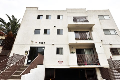 A tall white building with the number 2926 on the front.