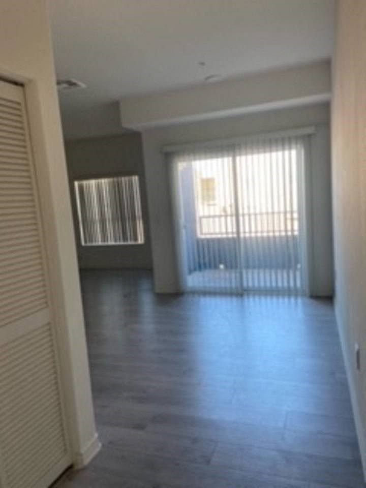 an empty living room with a sliding glass door