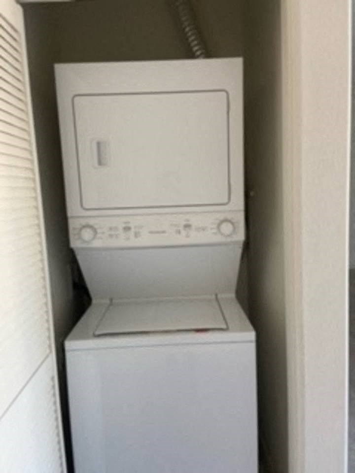a white washer and dryer in a small closet