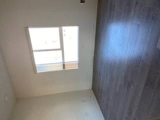 a small window in a room with a wooden wall