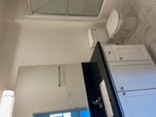 a bathroom with a toilet and a sink and a mirror