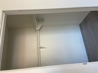 a closet with a mirror and a lamp in it