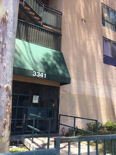 a building with a green awning and a staircase