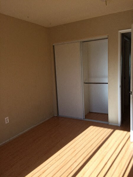 a room with a closet and a wooden floor