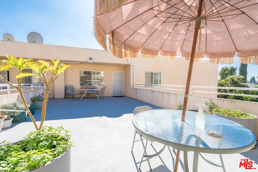 a patio with an umbrella and a table