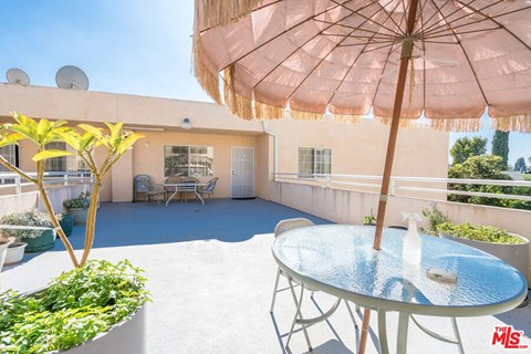 a patio with an umbrella and a table