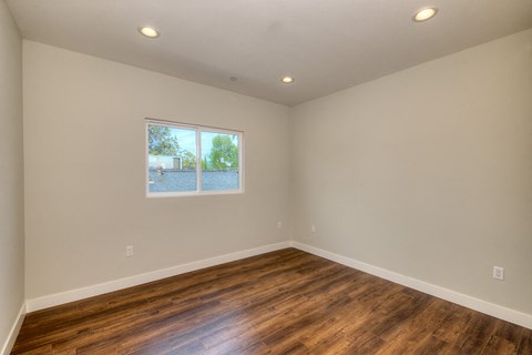 a living room with wood floors and a window