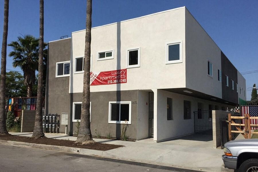 a white building with a red sign in front of it