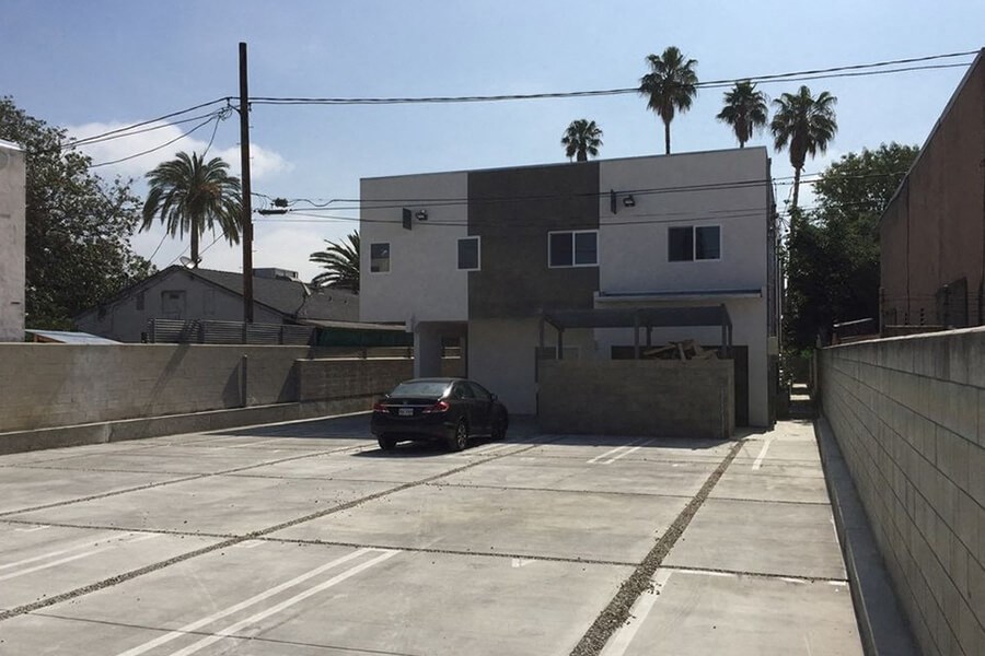 a car parked in a parking lot in front of a building