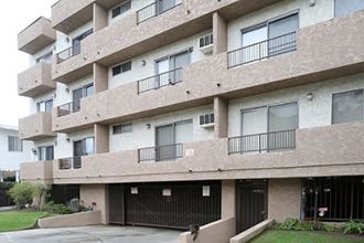 a large apartment building with garage doors in front of it