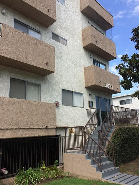 an apartment building with stairs in front of it