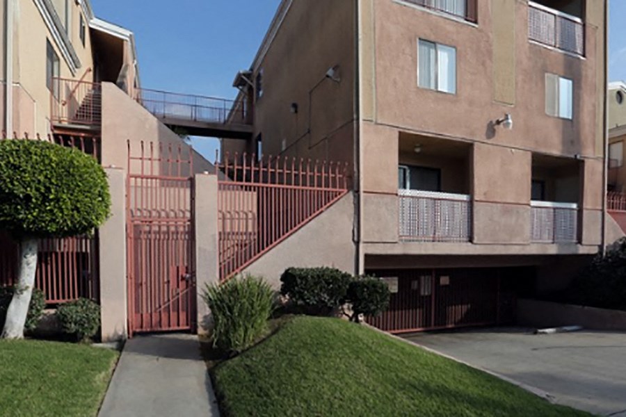 an exterior view of a building with stairs and a sidewalk