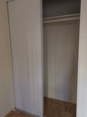 an empty room with a sliding closet door