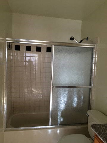 a bathroom with a shower and a toilet