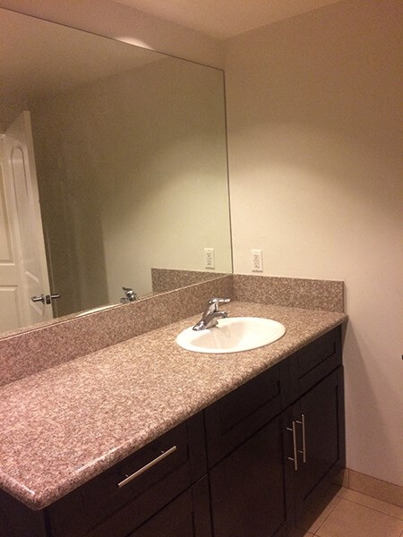 an empty bathroom with a sink and a mirror