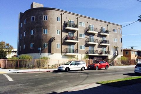 an apartment building with cars parked in front of it