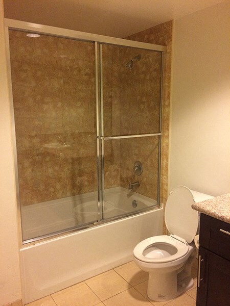 a bathroom with a toilet and a shower