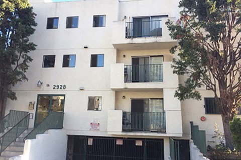 an apartment building with balconies and a staircase