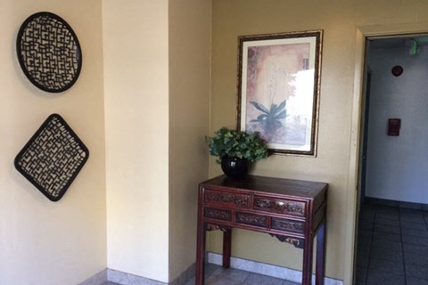 a vase with a plant on a table in a room