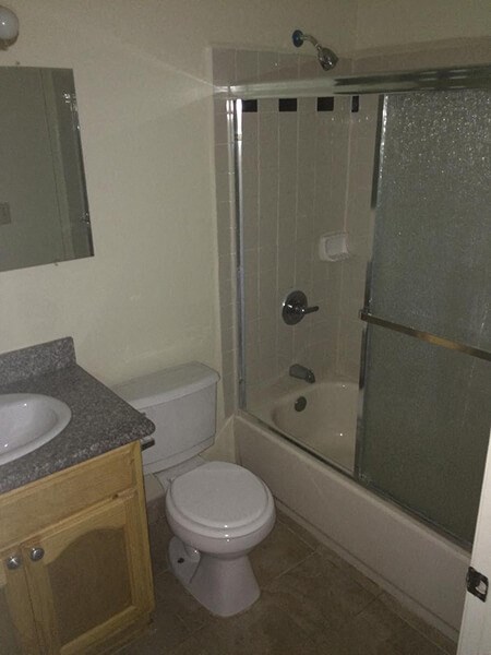a bathroom with a toilet and a sink and a shower
