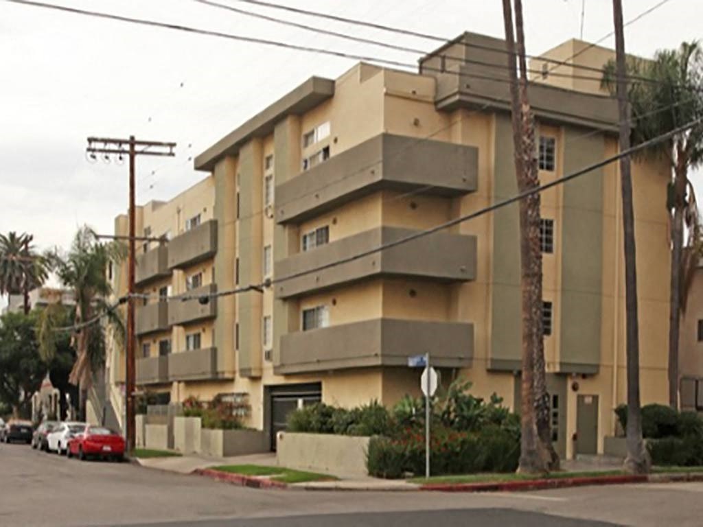 an apartment building on the corner of a street