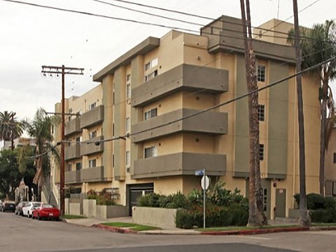 an apartment building on the corner of a street