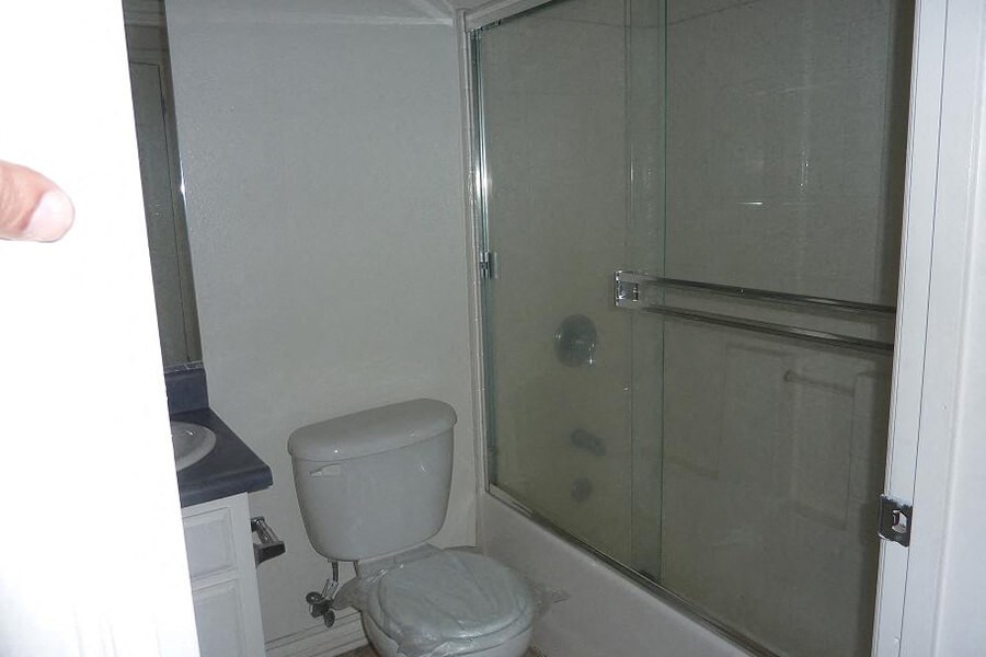 a bathroom with a toilet and a shower