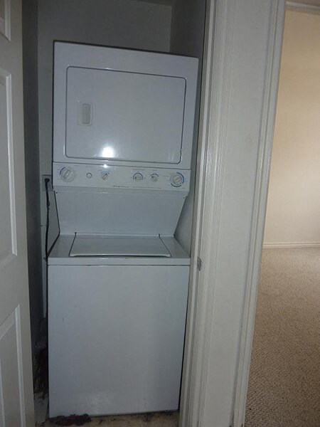 a white washer and dryer in a white door