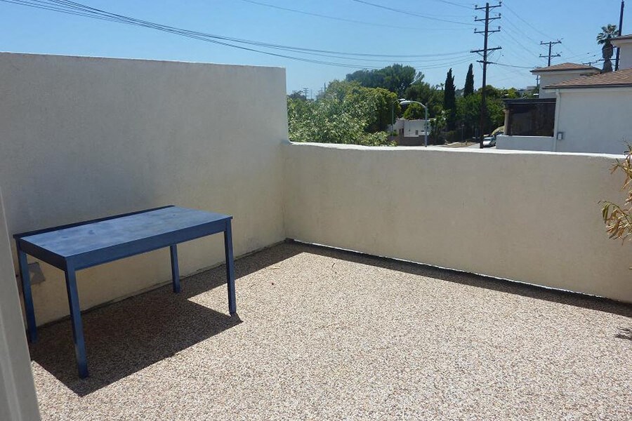 a blue table sitting next to a white wall
