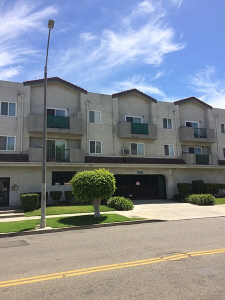 an apartment building on the corner of a street