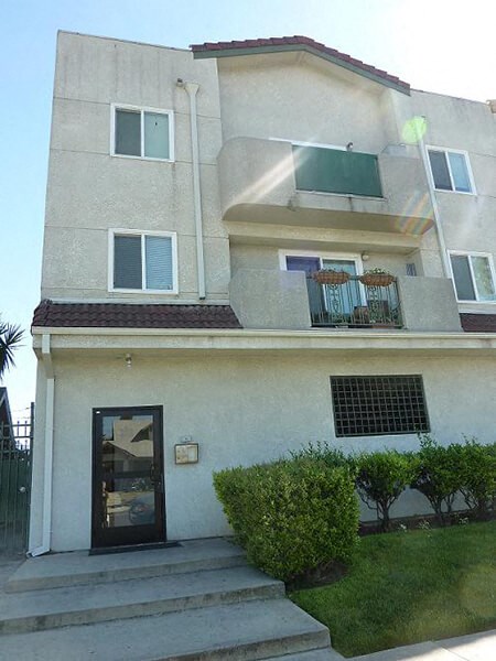 a white house with a door and a balcony