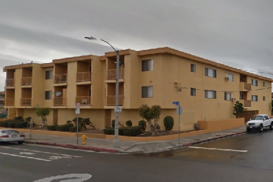 an apartment building on the corner of a city street