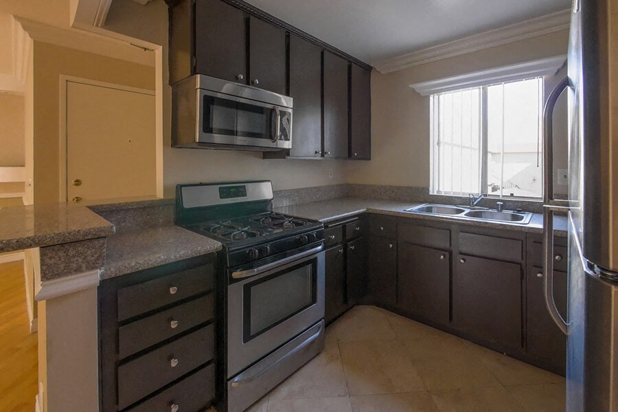 a kitchen with stainless steel appliances and granite counter tops