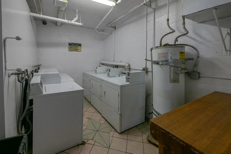 a laundry room with two washing machines and two sinks