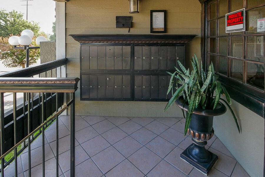 a plant in a vase on the balcony of a building