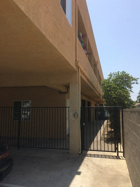 the side of a building with a fence and a gate