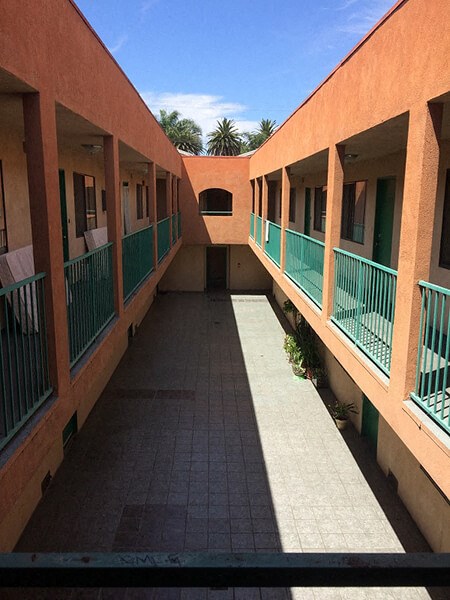 a corridor between two buildings with balconies