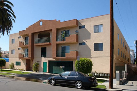 a car parked in front of an apartment building