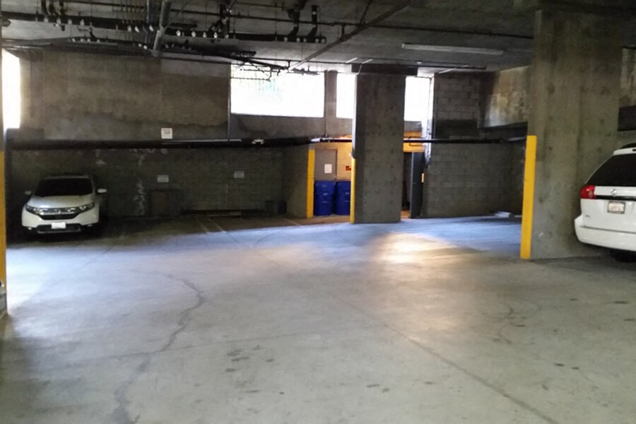 an empty parking garage with cars in it