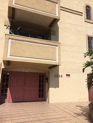 the entrance to a building with a red door