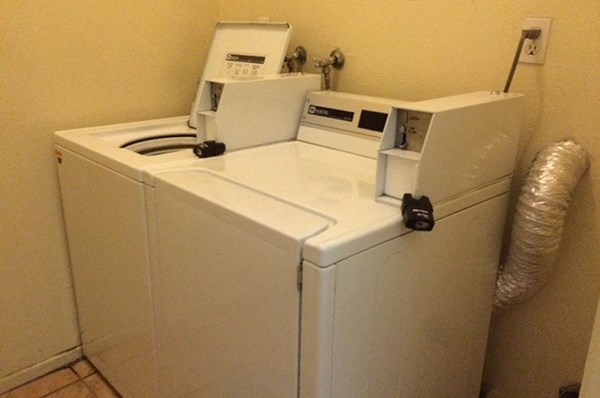 a white refrigerator with two machines on top of it