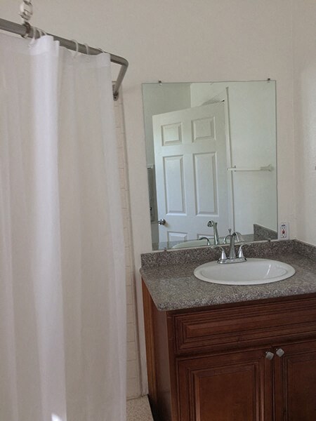 a bathroom with a sink and a shower curtain