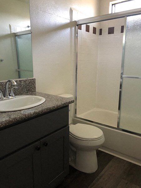 a bathroom with a sink toilet and shower