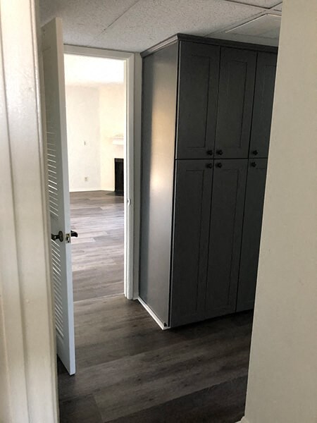 a hallway with a closet and a door open