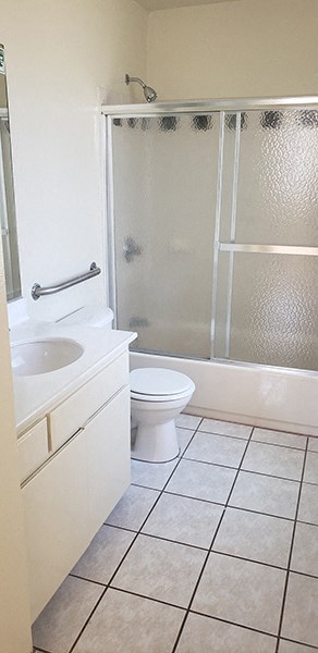a bathroom with a toilet and a sink and a shower